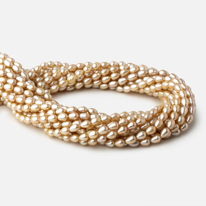 5.5x4.5-6.5x5mm Golden Beige straight drilled Oval freshwater pearls 16 inch 64 pieces A